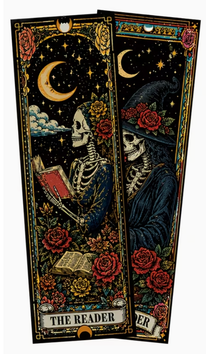 Two decorative illustrated bookmarks or tags with a dark gothic design, featuring a skeleton reading a book under a crescent moon and stars, surrounded by red roses and flowers. One is labeled 'THE READER' and the other is partially visible.