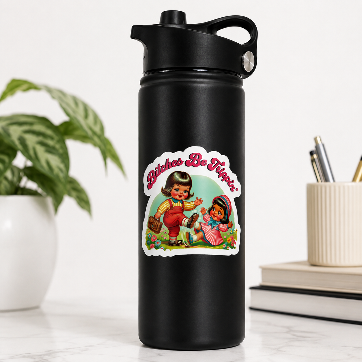 A matte black insulated water bottle with a flip-top lid stands on a light marble surface. A colorful retro-style sticker reading “Bitches Be Hipster” with illustrated figures is centered on the bottle.