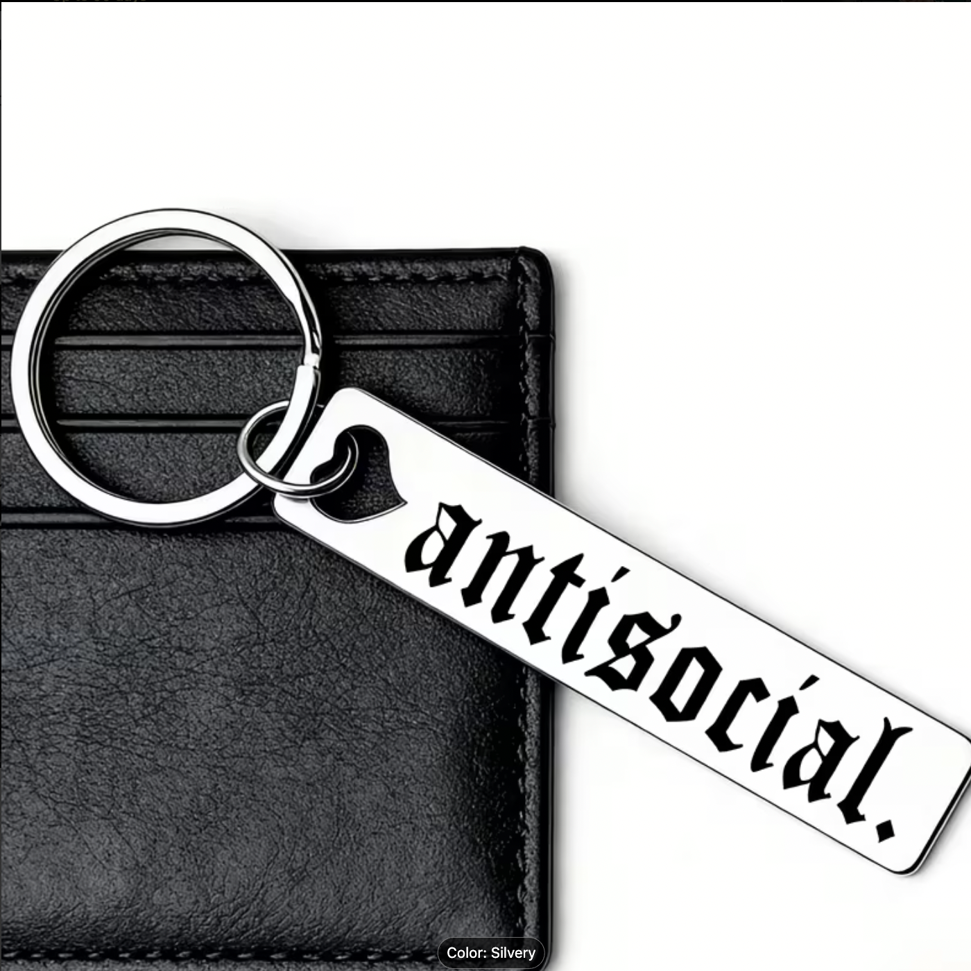 Keychain with 'antisocial' text on a black leather wallet background