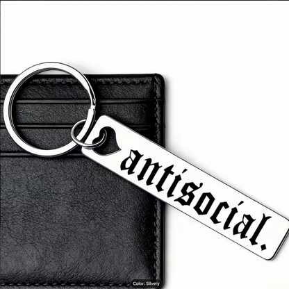 Keychain with 'antisocial' text on a black leather wallet background