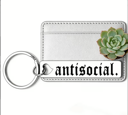 Keychain with 'antisocial' tag and succulent plant on a white background