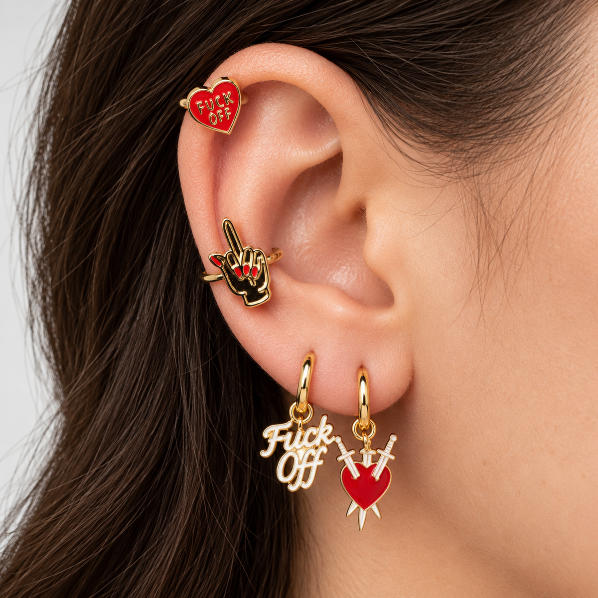Ear styled with two no-piercing cuffs and two mismatched gold hoop earrings