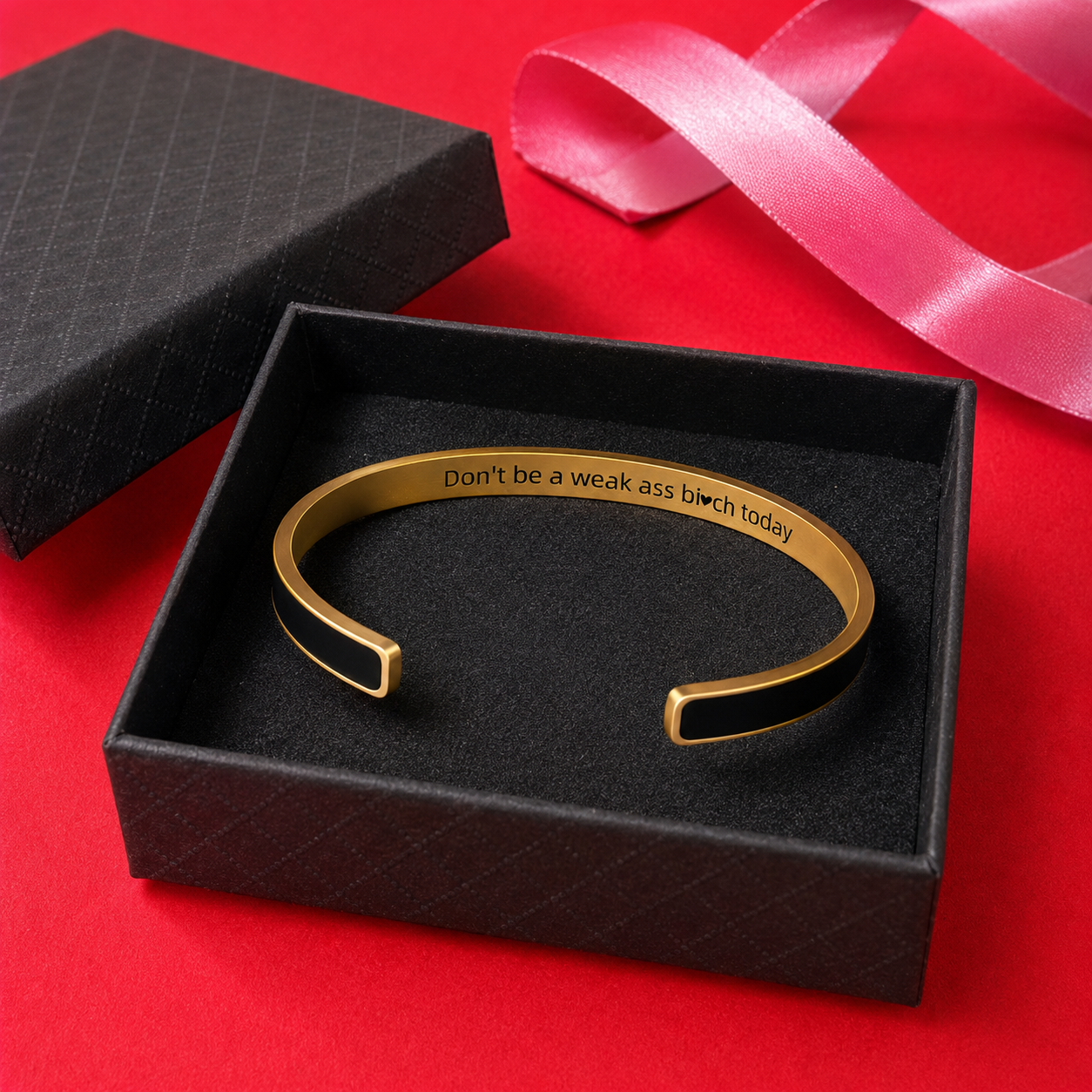 Black and gold hidden message cuff bracelet displayed in its included black gift box