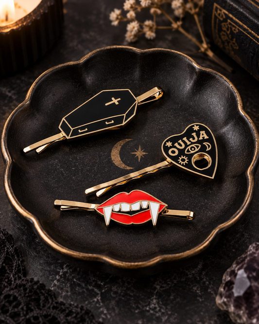 Coffin, Ouija and vampire lips enamel hair pins grouped in a black celestial dish