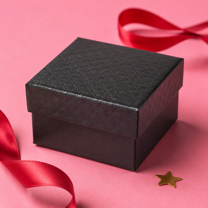 Included black quilted jewelry gift box displayed against a pink background