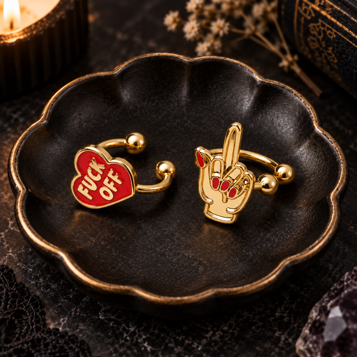 Gold and red ear cuffs in a dark scalloped jewelry dish