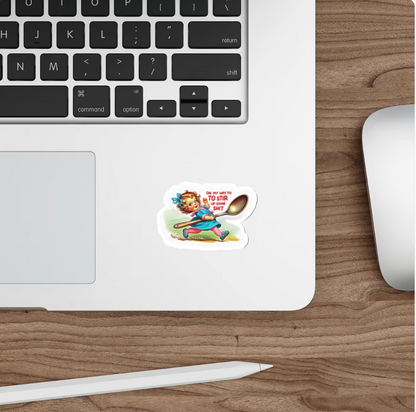 A die-cut sticker featuring a cartoon illustration of a girl with a spoon and the text 'I'M SURE YOU'RE NOT SUGAR FREE!' is shown applied to the lower left corner of a white laptop on a wooden desk, with a mouse and stylus nearby.